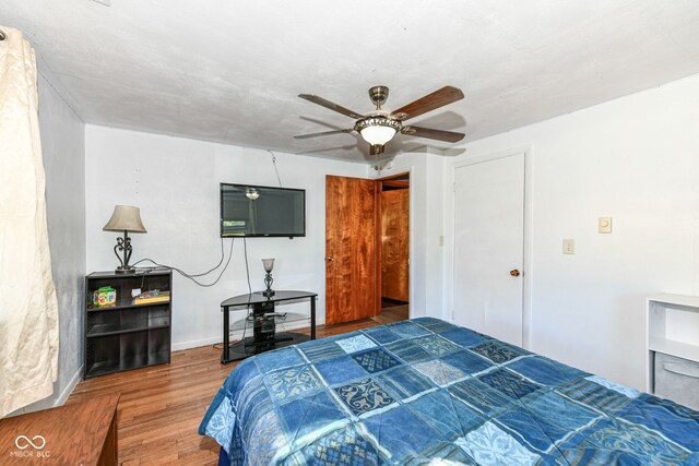 bedroom with ceiling fan and hardwood / wood-style floors