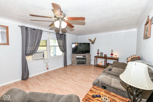 living room with ceiling fan, cooling unit, a textured ceiling, and light hardwood / wood-style flooring