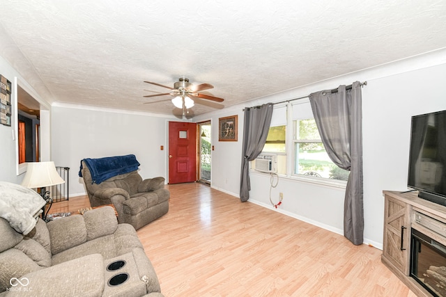 living room featuring light wood-type flooring, ceiling fan, a textured ceiling, and cooling unit