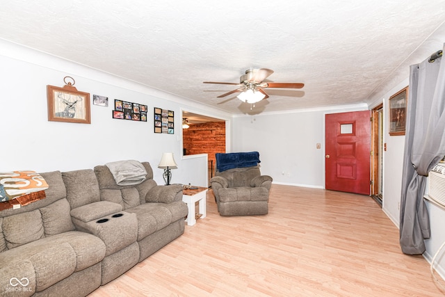 living room featuring ceiling fan, a textured ceiling, and light hardwood / wood-style flooring