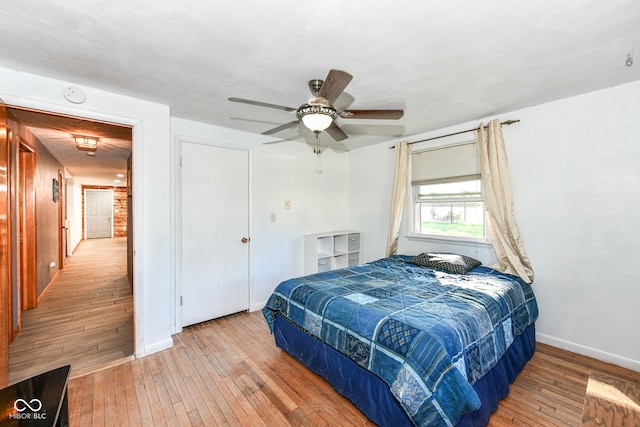 bedroom with ceiling fan and hardwood / wood-style floors