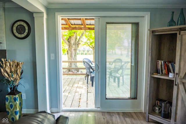 doorway to outside with crown molding and wood-type flooring