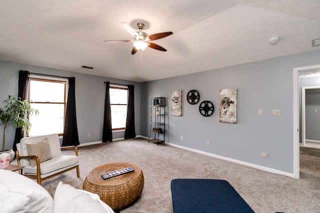 carpeted living room with ceiling fan