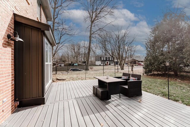 wooden terrace with an outdoor living space