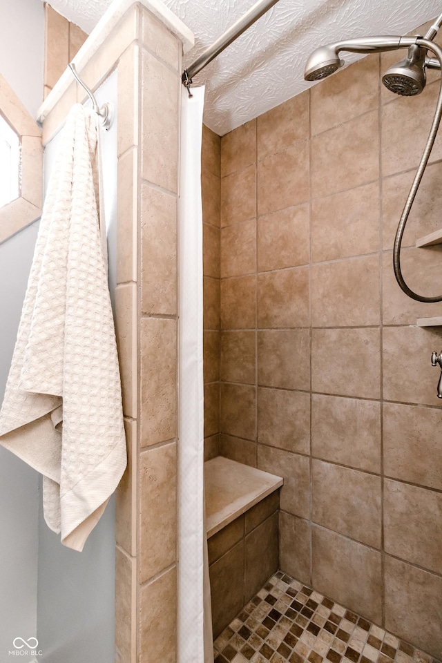 bathroom featuring a textured ceiling and walk in shower