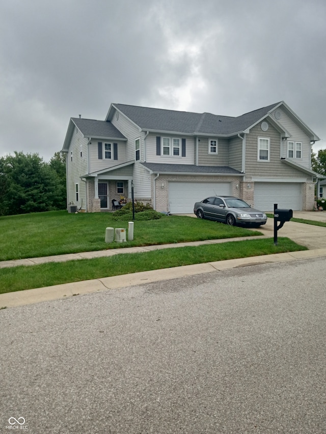 view of front facade featuring a garage and a front lawn