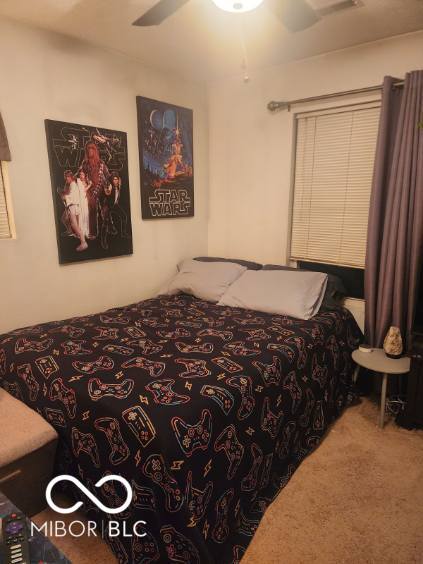 carpeted bedroom featuring ceiling fan