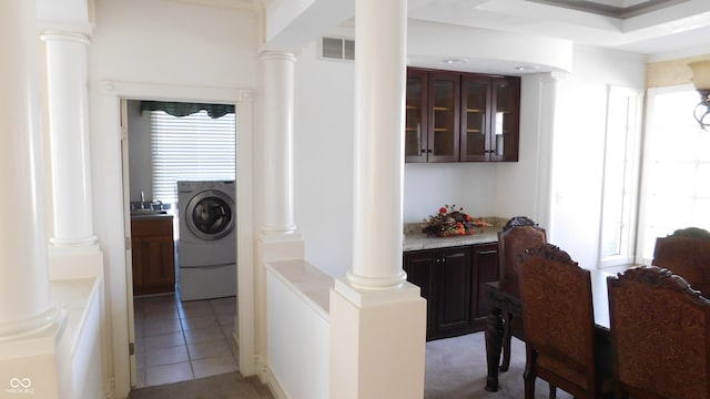 washroom with washer / clothes dryer, light tile patterned flooring, and crown molding