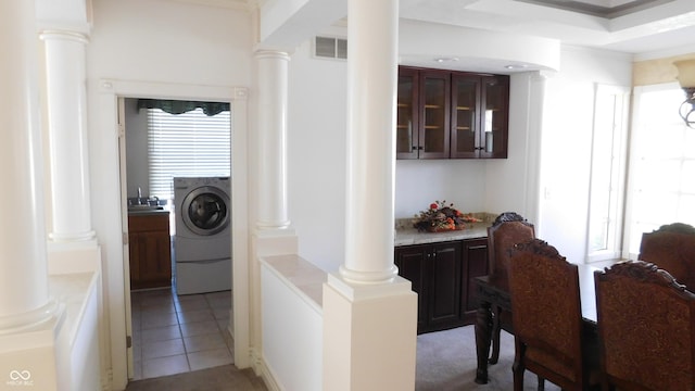 10781 Cedar Ridge Ln, Brownsburg, IN 46278 - hallway featuring washer / clothes dryer, light tile patterned floors, ornate columns, and a sink
