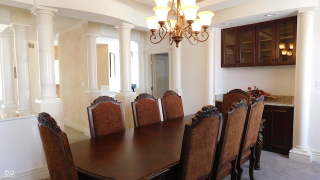 dining area featuring carpet floors, ornamental molding, and a chandelier