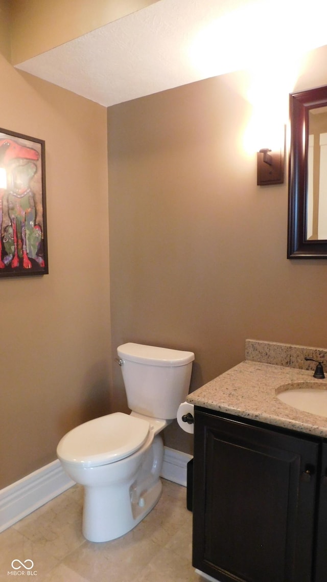 10781 Cedar Ridge Ln, Brownsburg, IN 46278 - half bath with toilet, tile patterned floors, baseboards, and vanity