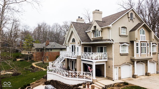 10781 Cedar Ridge Ln, Brownsburg, IN 46278 - view of front of property featuring stairway, brick siding, a chimney, a garage, and concrete driveway