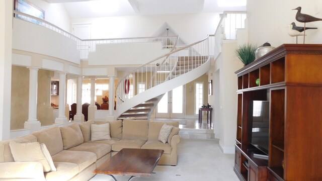 10781 Cedar Ridge Ln, Brownsburg, IN 46278 - living area featuring carpet floors, decorative columns, a high ceiling, and stairway