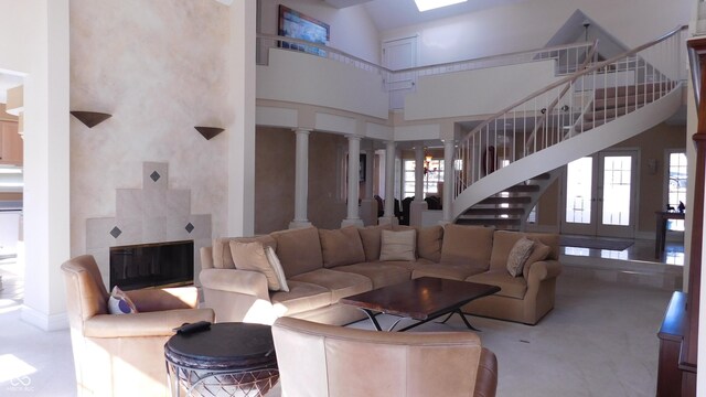 10781 Cedar Ridge Ln, Brownsburg, IN 46278 - living area with ornate columns, a towering ceiling, and stairs
