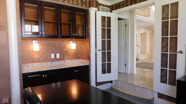 10781 Cedar Ridge Ln, Brownsburg, IN 46278 - kitchen with glass insert cabinets, visible vents, french doors, backsplash, and light stone counters