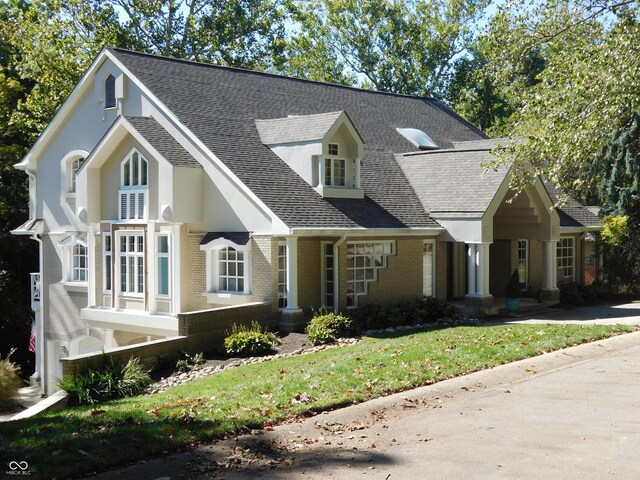 10781 Cedar Ridge Ln, Brownsburg, IN 46278 - view of front of house with roof with shingles, a front lawn, and brick siding