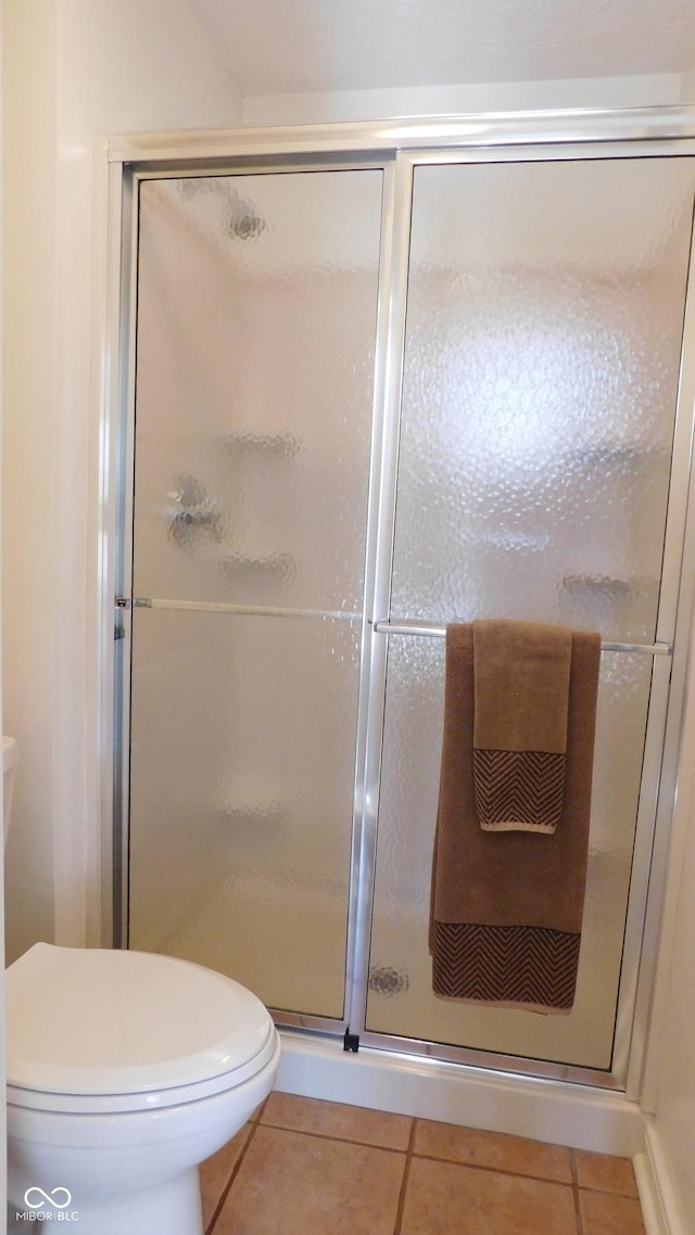 10781 Cedar Ridge Ln, Brownsburg, IN 46278 - bathroom featuring a shower stall and tile patterned flooring
