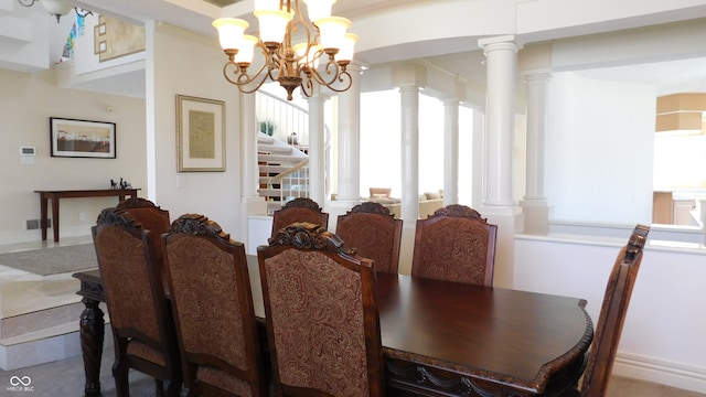 dining room with an inviting chandelier and ornate columns