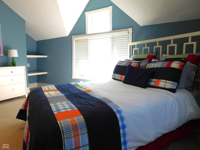 carpeted bedroom with vaulted ceiling