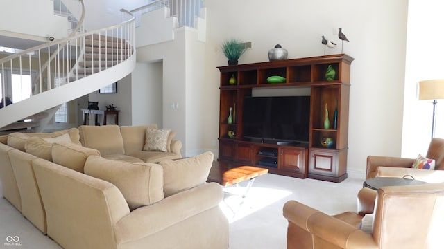 living room featuring light carpet and a high ceiling