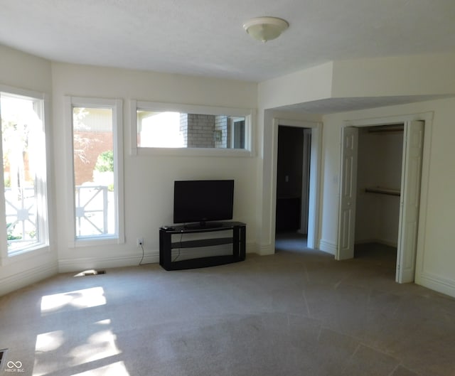 unfurnished living room with light colored carpet