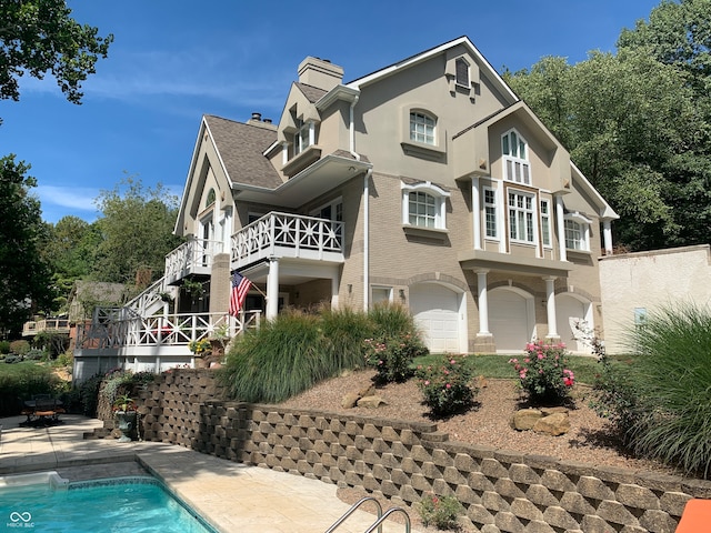 exterior space with a fenced in pool and a garage