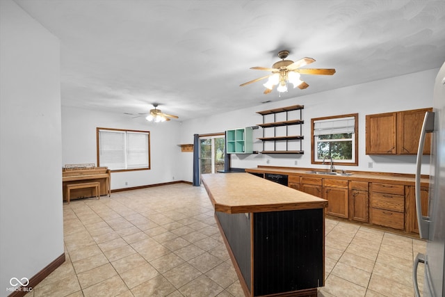 kitchen with sink, ceiling fan, and a wealth of natural light