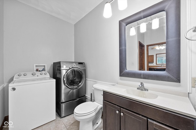 bathroom with vanity, toilet, washing machine and clothes dryer, and tile patterned floors