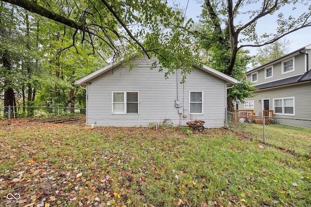 rear view of property with a yard