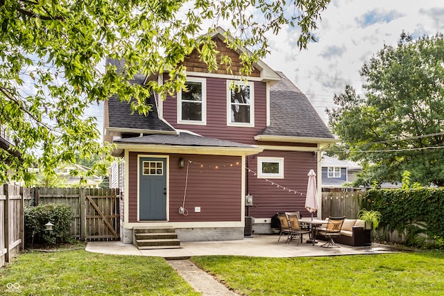 back of house with a yard and a patio area