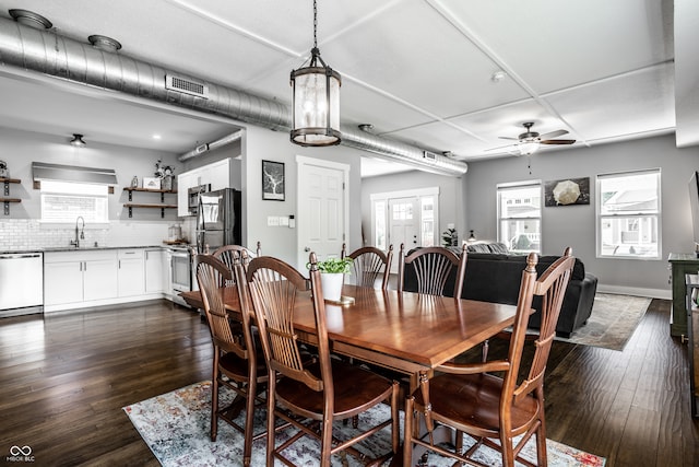 dining space featuring ceiling fan, dark hardwood / wood-style floors, sink, and a healthy amount of sunlight