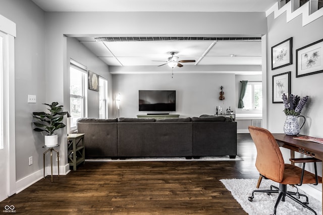 living room with ceiling fan and dark hardwood / wood-style floors