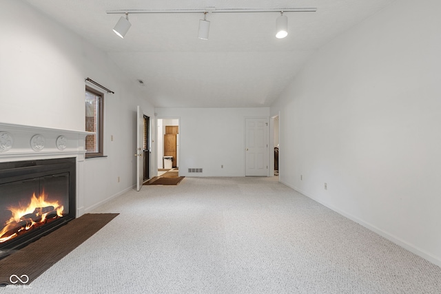 living room featuring rail lighting and light colored carpet