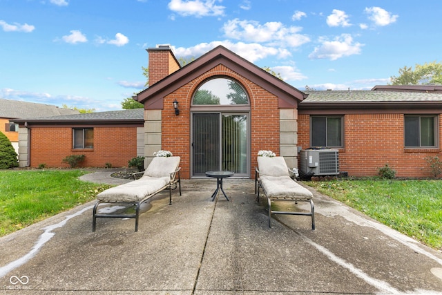 rear view of house featuring central AC and a patio area