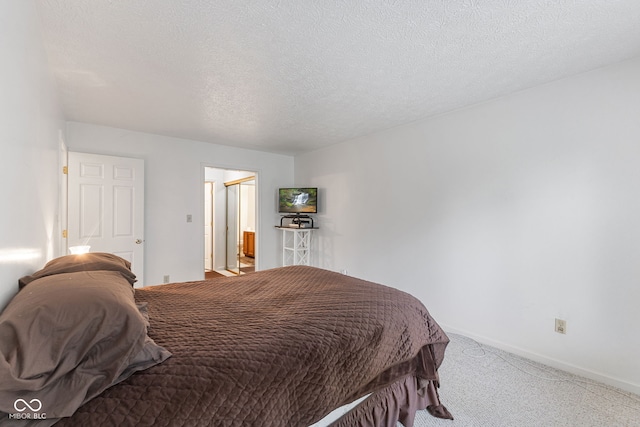 bedroom with a textured ceiling and carpet flooring