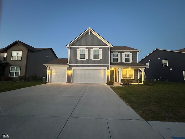 view of front of house with a garage and a yard