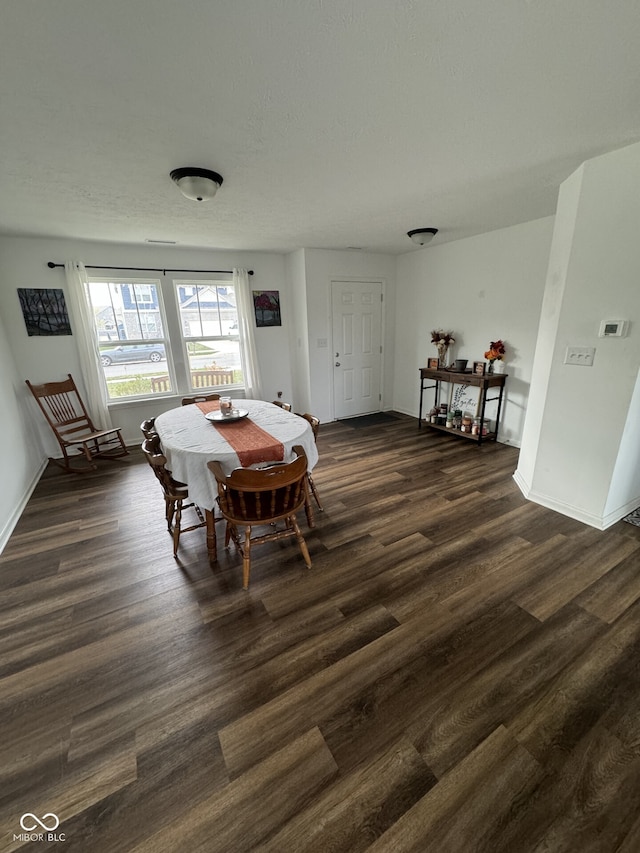 dining room with dark hardwood / wood-style flooring