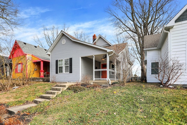 bungalow-style home with covered porch and a front yard