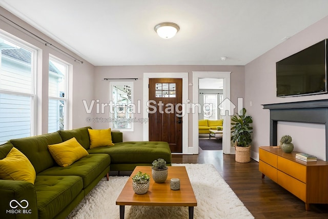 living area with a healthy amount of sunlight, baseboards, and dark wood-style flooring