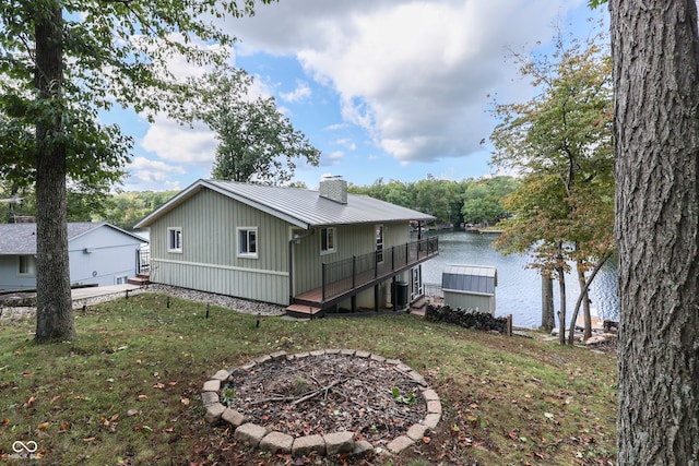 7438 Haw Dr, Nineveh, IN 46164 - rear view of property featuring central AC, a water view, metal roof, a lawn, and a chimney