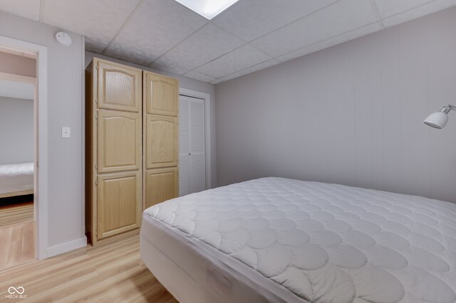 bedroom featuring light wood-type flooring and a closet