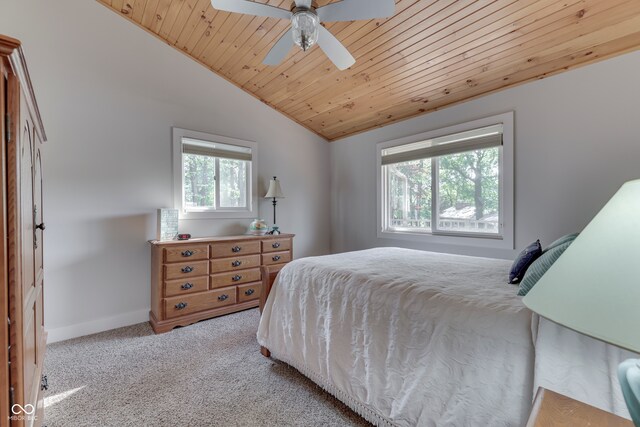 carpeted bedroom with multiple windows, lofted ceiling, ceiling fan, and wooden ceiling