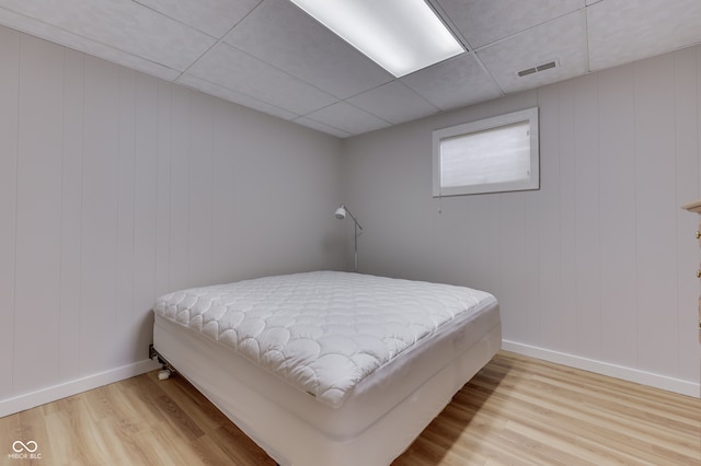 7438 Haw Dr, Nineveh, IN 46164 - bedroom featuring visible vents, baseboards, a paneled ceiling, and wood finished floors