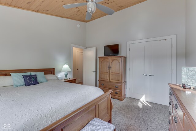 bedroom featuring wooden ceiling, ceiling fan, light colored carpet, and high vaulted ceiling