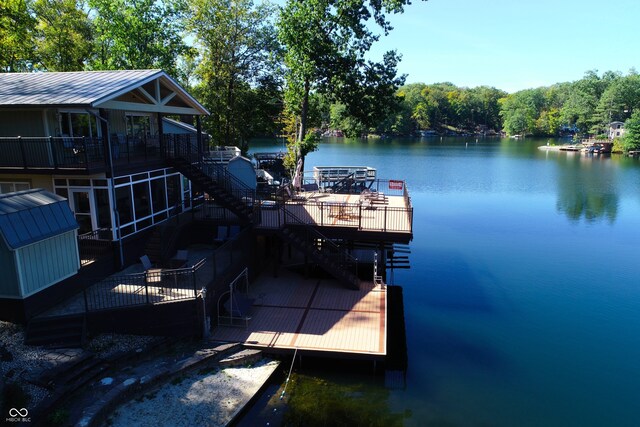 dock area featuring a deck with water view