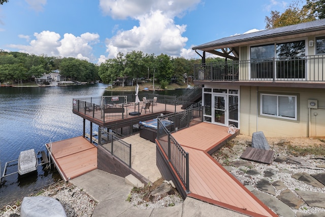 dock area featuring a deck with water view