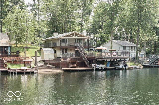 dock area featuring a deck with water view