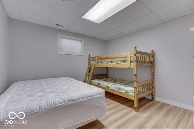 7438 Haw Dr, Nineveh, IN 46164 - bedroom featuring visible vents, baseboards, a drop ceiling, and wood finished floors