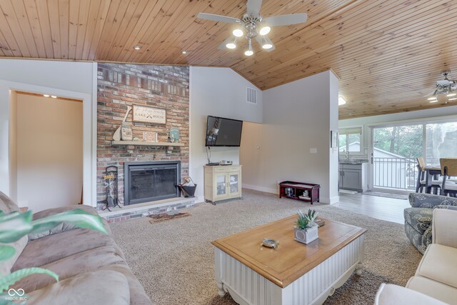 carpeted living room featuring wooden ceiling, a fireplace, and ceiling fan