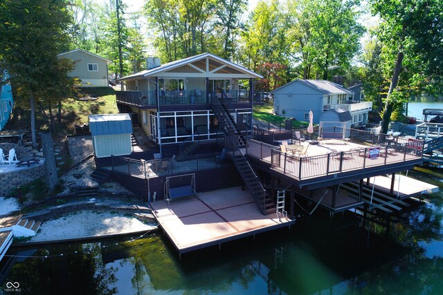 rear view of property with a deck with water view